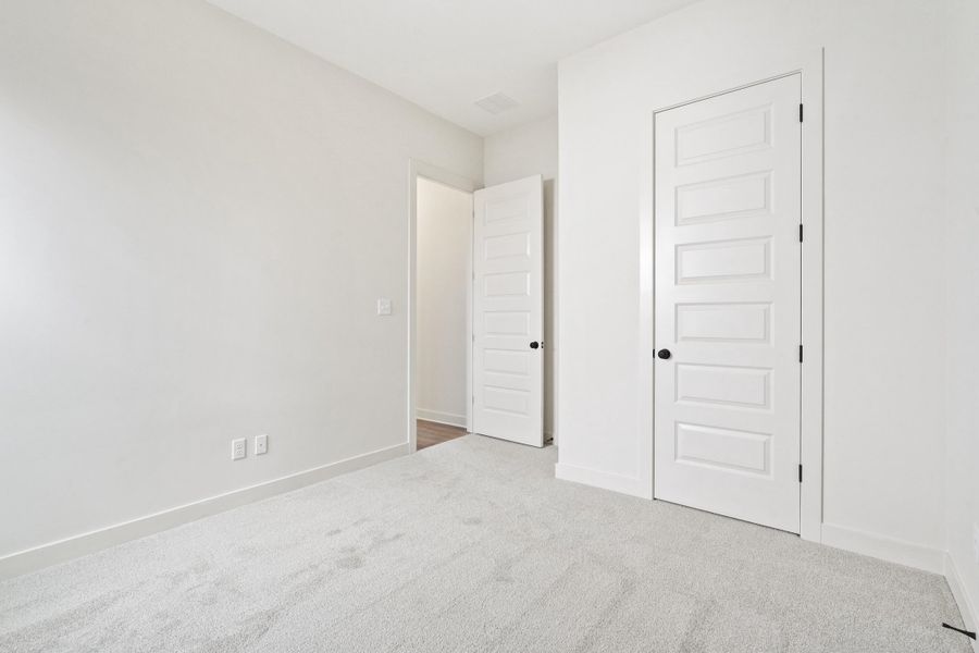 Unfurnished bedroom with carpet floors and a closet