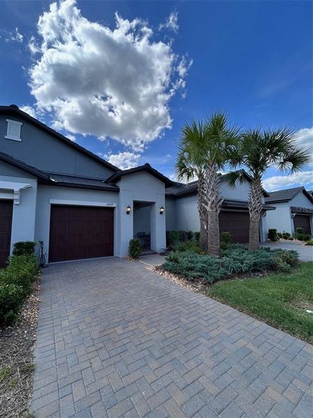 Front exterior of a new home in Angeline Active Adult, Land O' Lakes, FL, highlighting curb appeal (Image 2). Front exterior of a new home in Angeline Active Adult, Land O' Lakes, FL, highlighting curb appeal (Image 2).