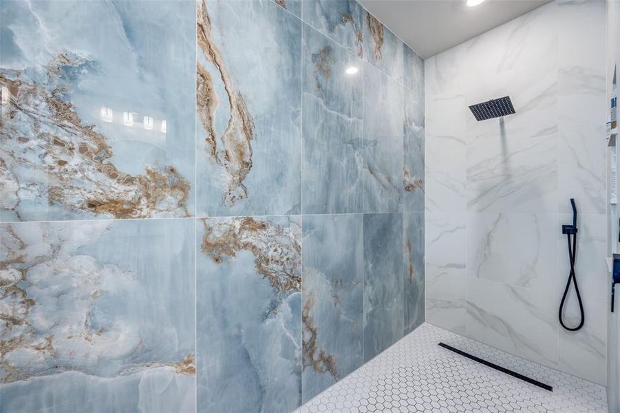 Full bath featuring a marble finish shower