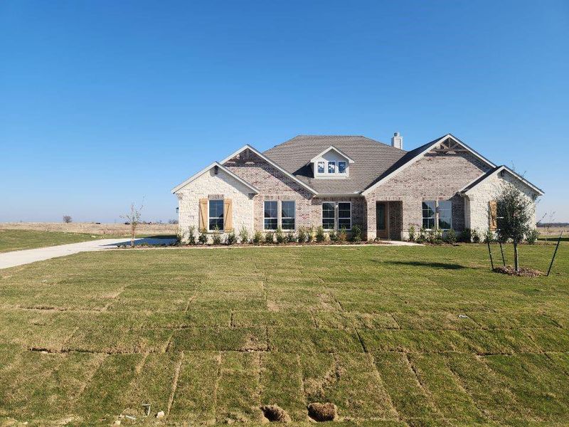 Front exterior of a new home in Rocky Top, Krum, TX, highlighting curb appeal (Image 2).