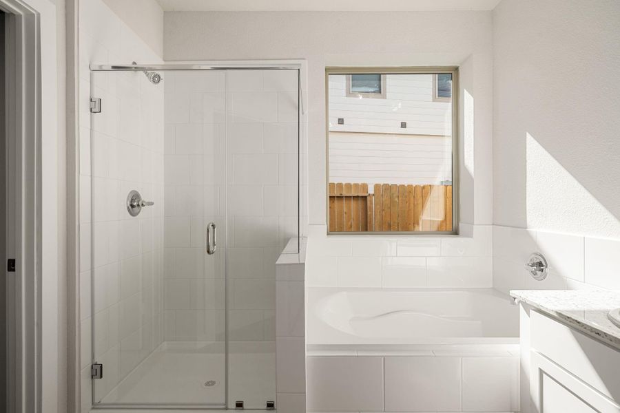 This spa-inspired bathroom showcases dual sinks, a spacious vanity, and a soaking tub beside a large window for natural light. The sleek finishes and neutral palette offer a calm, modern retreat. This spa-inspired bathroom showcases dual sinks, a spacious vanity, and a soaking tub beside a large window for natural light. The sleek finishes and neutral palette offer a calm, modern retreat.
