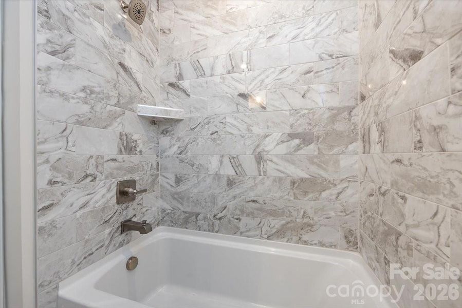 Secondary Bathroom with tiled walls above the tub