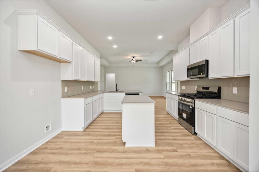 The kitchen opens up to the breakfast/dining nook. The kitchen opens up to the breakfast/dining nook.