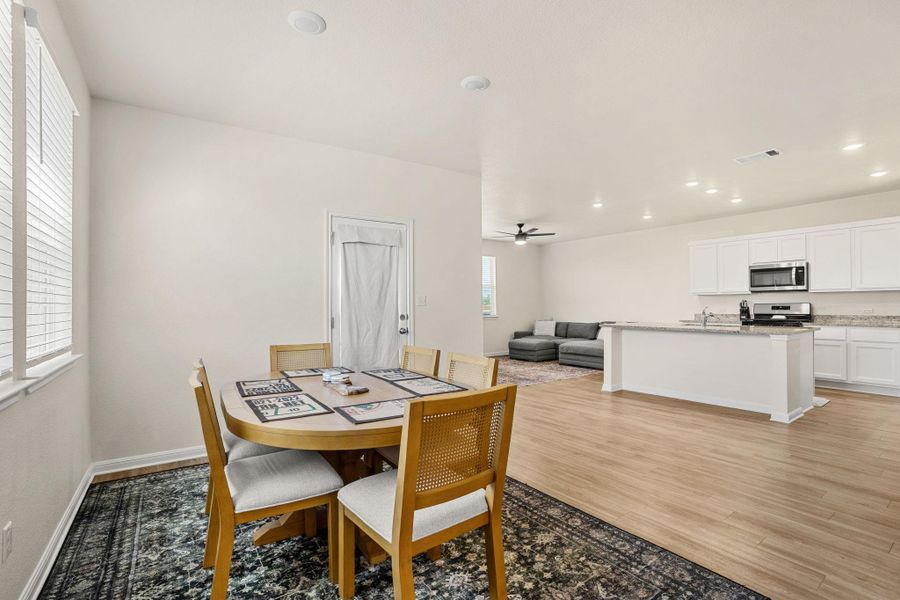 An inviting open-concept layout features rich hardwood flooring throughout the main living areas.