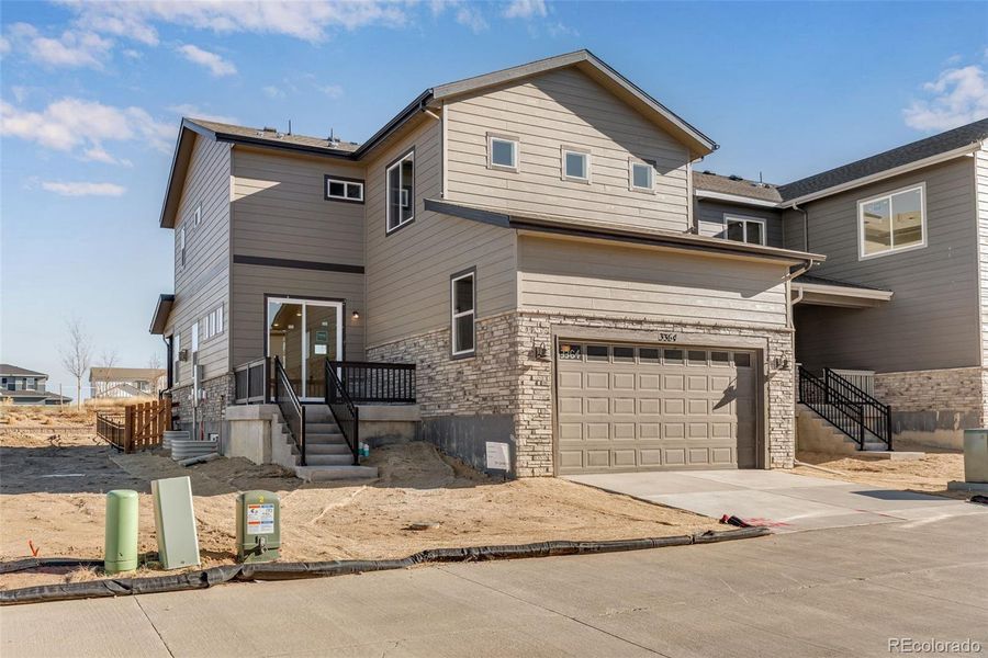 Front exterior of a new home in Crescendo at The Aurora Highlands, Aurora, CO, highlighting curb appeal (Image 28).