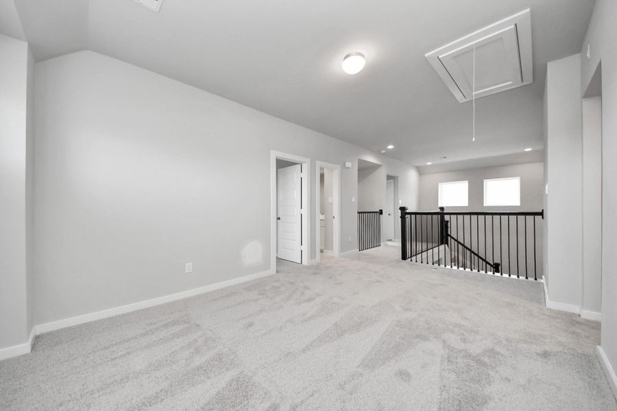 Ascend to relaxation in this fantastic game room! Ideal for both casual gatherings and adult gaming, it boasts plush carpet, lofty ceilings, custom paint, and ample windows for abundant natural light.