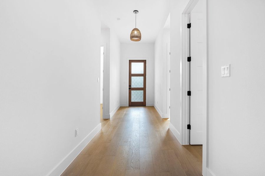 Hallway featuring light hardwood / wood-style flooring Hallway featuring light hardwood / wood-style flooring