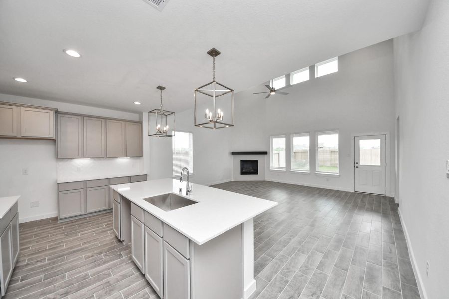 Step into a dream realized with this generously spacious kitchen! A massive granite island takes center stage, complemented by high ceilings and soft-close cabinets. The granite countertops, stainless steel appliances, sleek tile backsplash, and recessed lighting complete the elegant design. Step into a dream realized with this generously spacious kitchen! A massive granite island takes center stage, complemented by high ceilings and soft-close cabinets. The granite countertops, stainless steel appliances, sleek tile backsplash, and recessed lighting complete the elegant design.