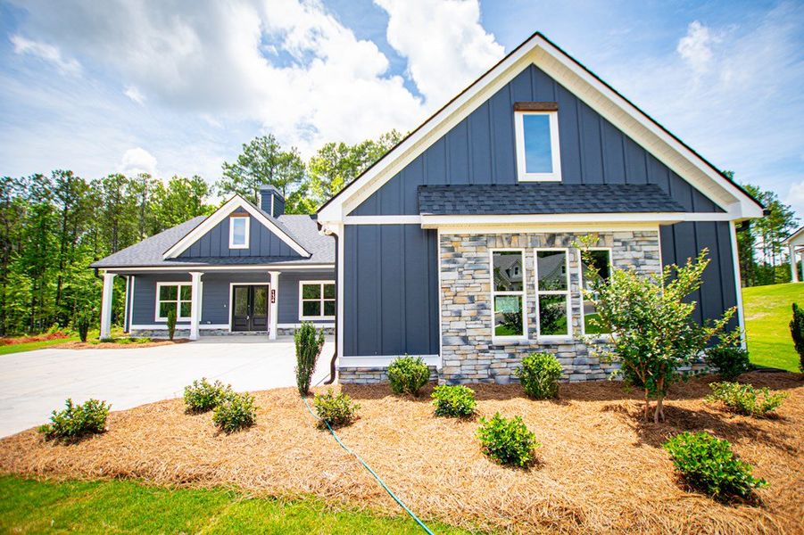 Front exterior of a new home in WOODMONT RESERVE, Roopville, GA, highlighting curb appeal (Image 35).