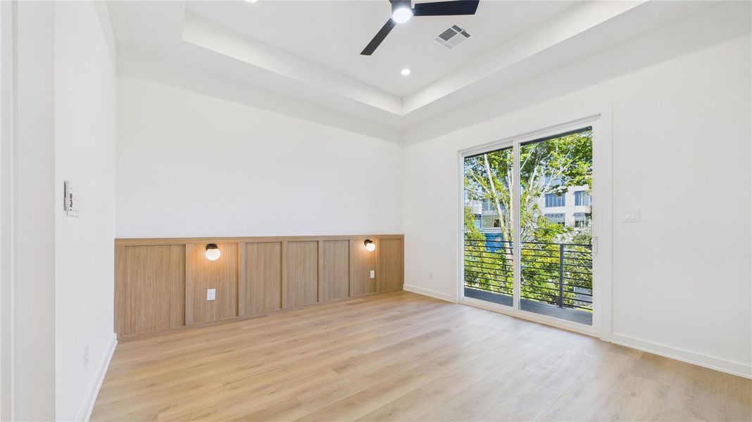 Empty bedroom skyline view with panelling and in-wall lamps