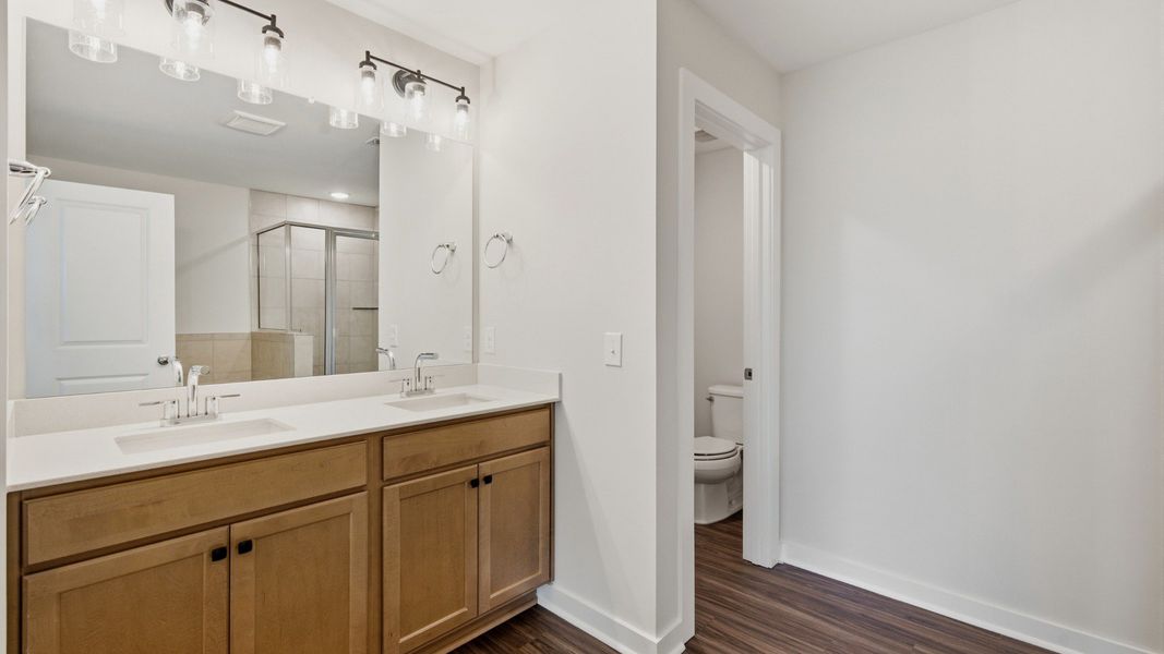Water closet next to dual sinks