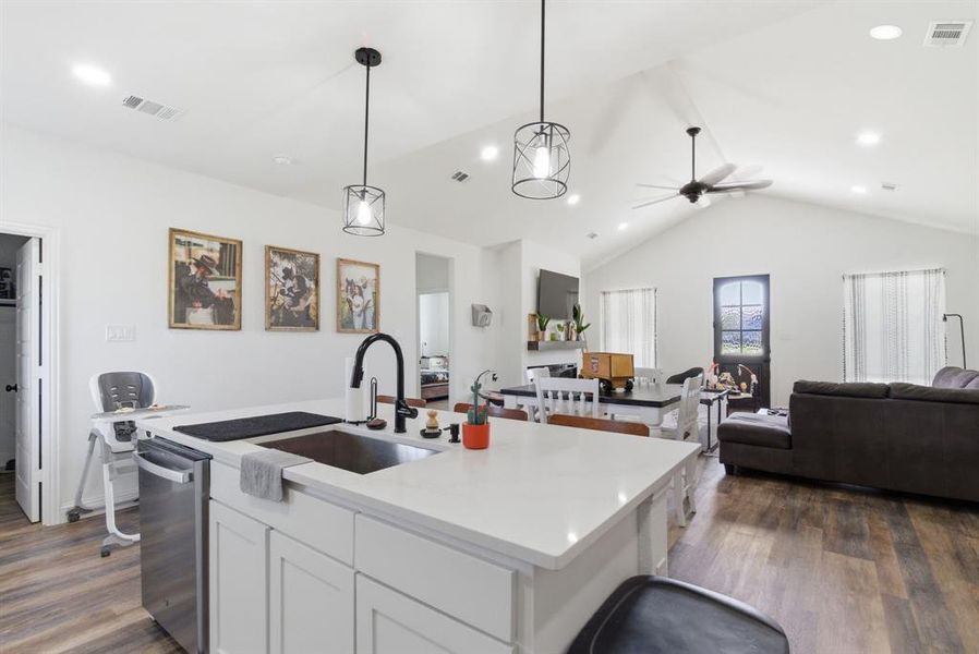 Kitchen with open floor plan, white cabinets, dark wood-style floors, a ceiling fan, and a high ceiling Kitchen with open floor plan, white cabinets, dark wood-style floors, a ceiling fan, and a high ceiling