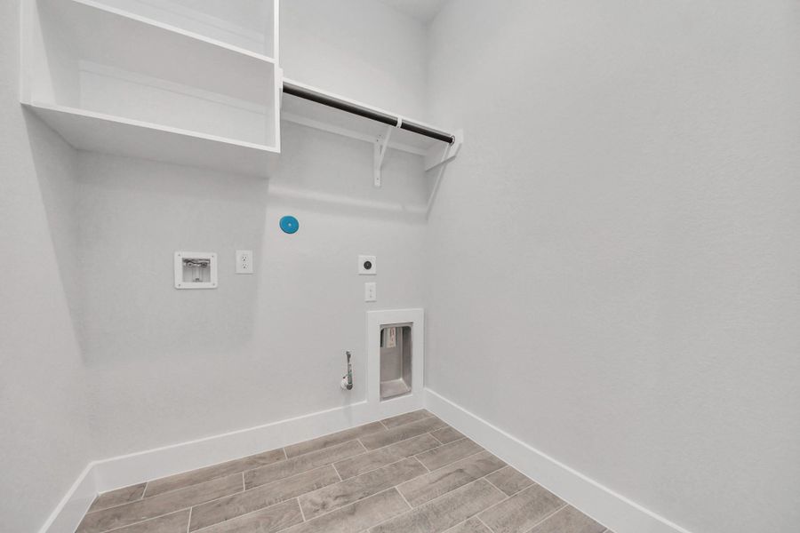 A perfect blend of functionality and comfort. Capture the essence of easy living with a first-floor laundry room, thoughtfully equipped with shelving for effortless organization. Both electric and gas connections available.