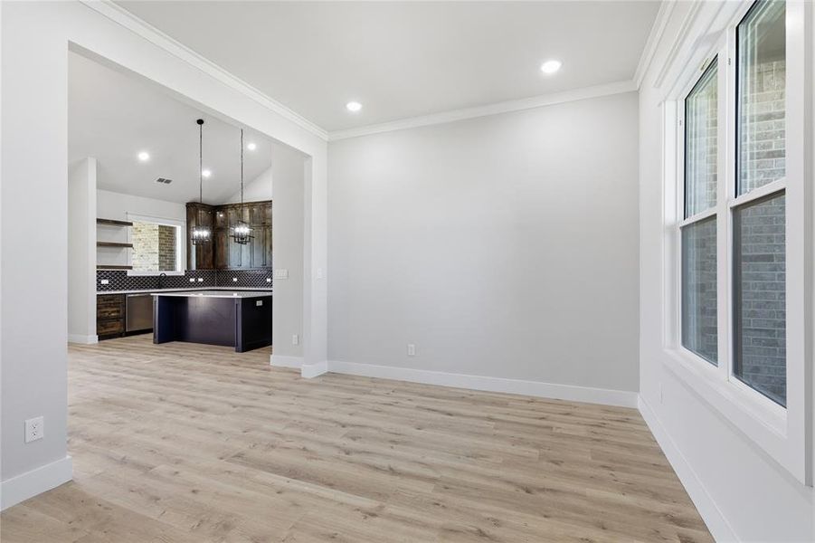 Spacious interior featuring wood-finish flooring, recessed lighting, and white baseboards