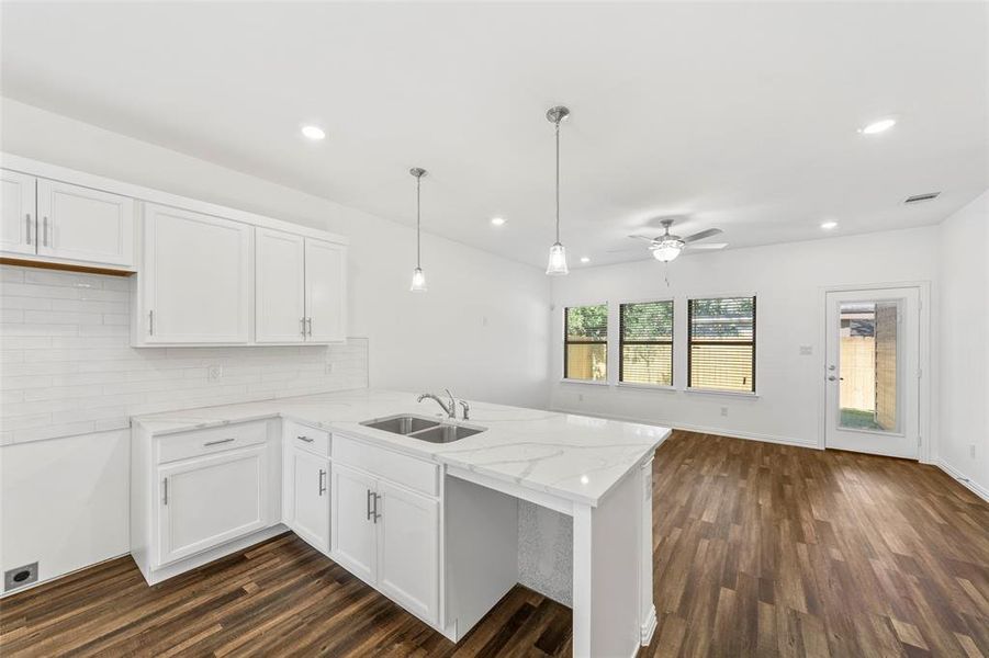 Kitchen featuring white cabinets, kitchen peninsula, ceiling fan, and dark hardwood / wood-style flooring