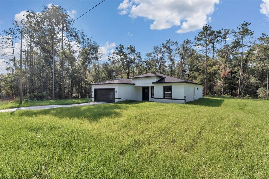 Front exterior of a new home in , Dunnellon, FL, highlighting curb appeal (Image 25).