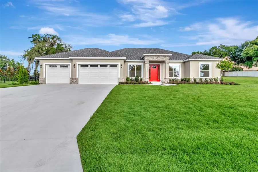 Front exterior of a new home in , Montverde, FL, highlighting curb appeal (Image 23). Front exterior of a new home in , Montverde, FL, highlighting curb appeal (Image 23).