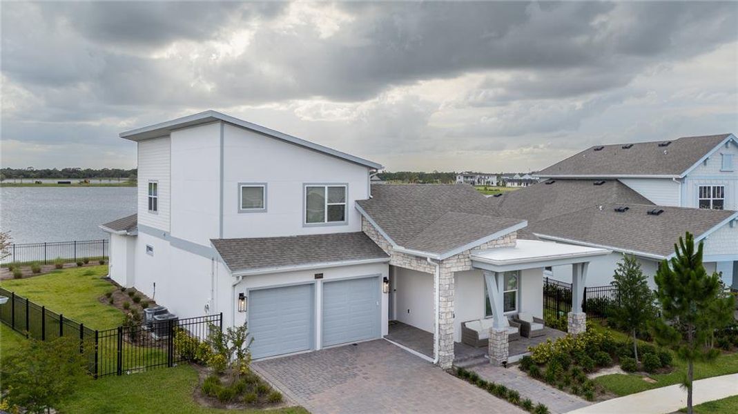 Front exterior of a new home in Laureate Park, Orlando, FL, highlighting curb appeal (Image 26). Front exterior of a new home in Laureate Park, Orlando, FL, highlighting curb appeal (Image 26).