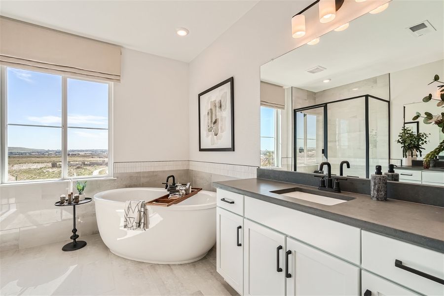 A bathroom with a tub sink and a large window. A bathroom with a tub sink and a large window.