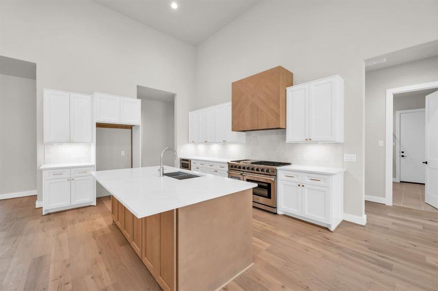 Impressive kitchen with high-end appliances, quartz counters and two-tone cabinetry. Kitchen cabinets are solid wood, with soft close drawers and doors!