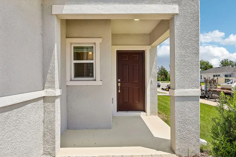 Exterior details and patio area of a home in Reserve at Forest Lake Townhomes, Lake Wales (Image 3).