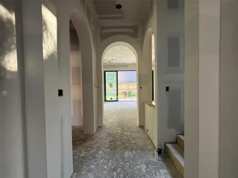 As you enter the front door, you're greeted by arches upon arches and soaring 12' ceilings.