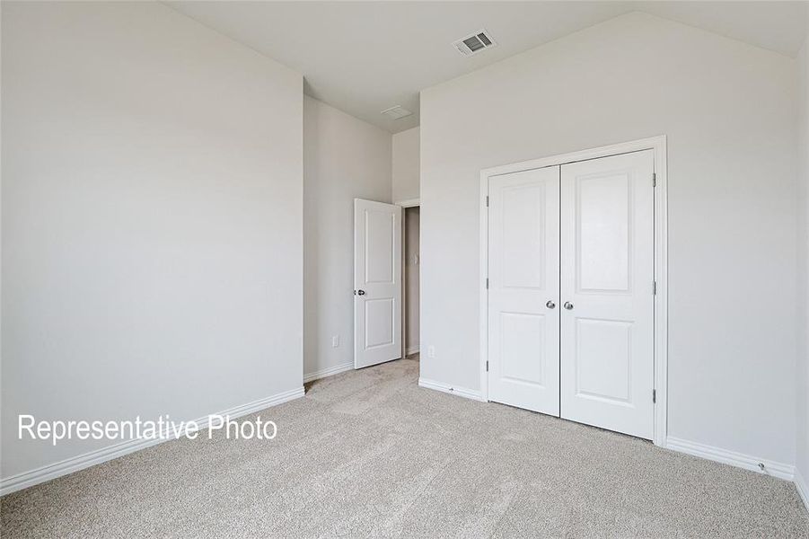 Unfurnished bedroom with a closet and light carpet