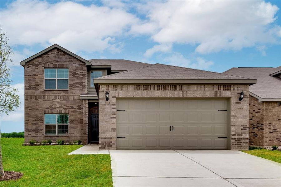 View of front of house with a garage and a front yard