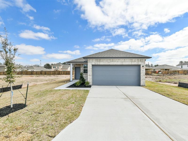 Front exterior of a new home in Liberty Estates, Cleveland, TX, highlighting curb appeal (Image 2).