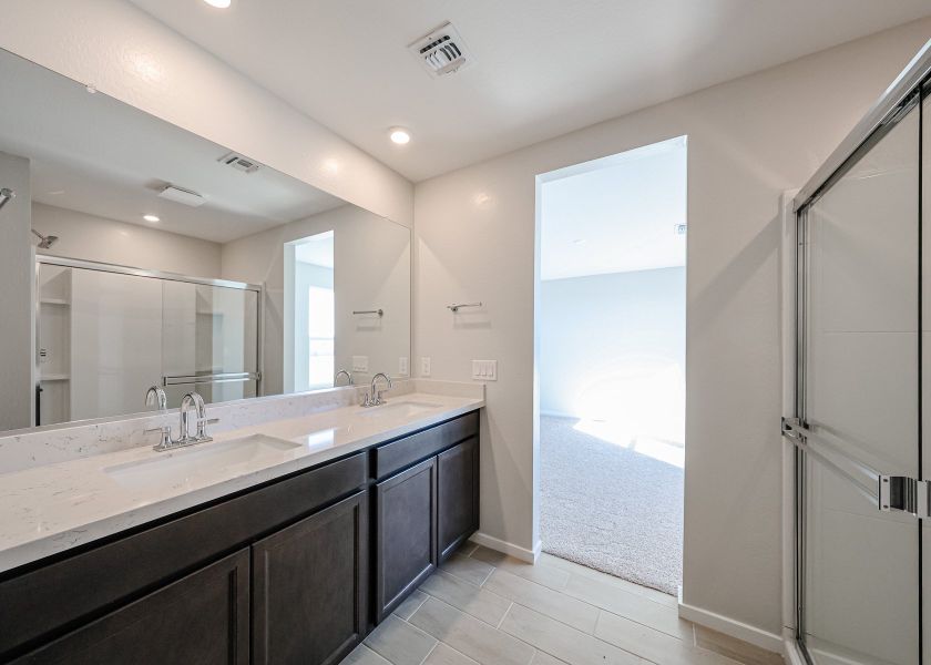 A bathroom with a large mirror.