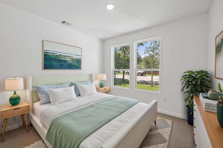 Naturally illuminated bedroom with expansive windows, showcasing treetop views and serene surroundings. Naturally illuminated bedroom with expansive windows, showcasing treetop views and serene surroundings.