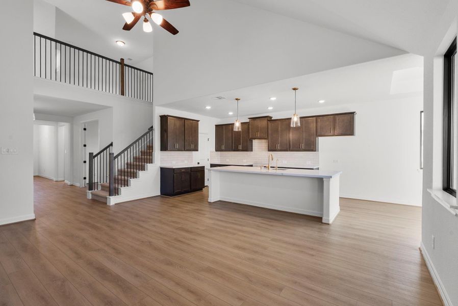 Open living room with view to kitchen and entry