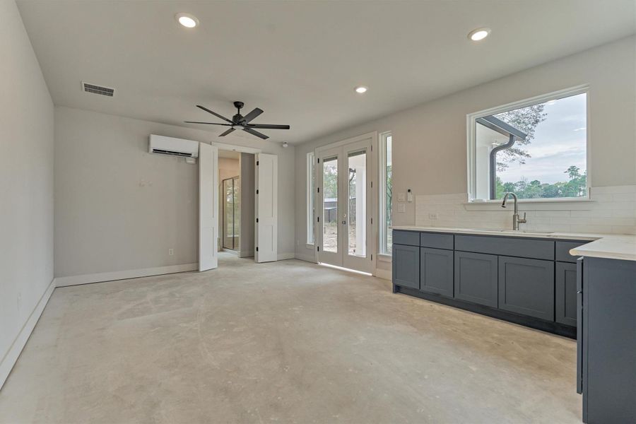 Beautifully finished casita with its own kitchen, private entrance, and full climate control.  Casita kitchenette features sleek navy cabinetry, subway tile backsplash, and private patio access—ideal for extended-stay guests or multi-generational living.