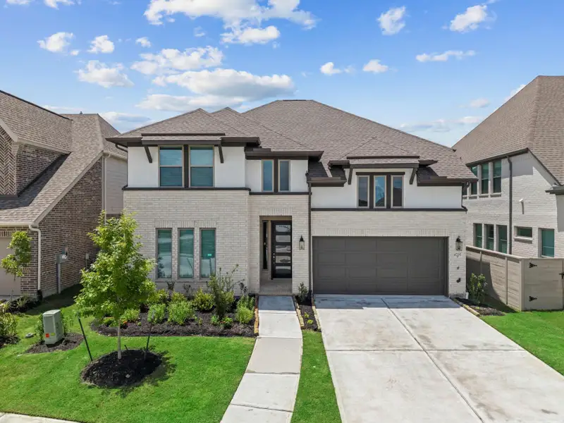 Front exterior of a new home in Legacy, League City, TX, highlighting curb appeal (Image 2). Front exterior of a new home in Legacy, League City, TX, highlighting curb appeal (Image 2).