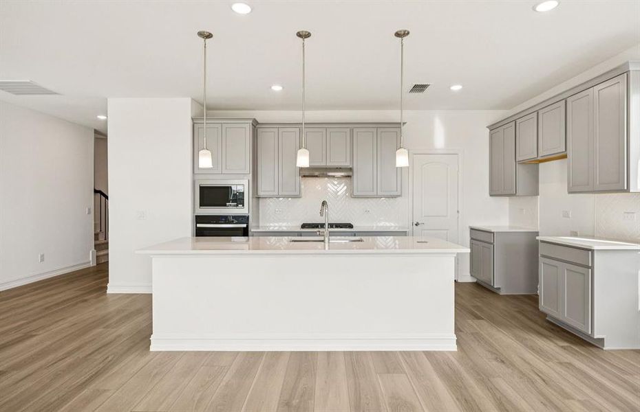 Open kitchen with pendants over island