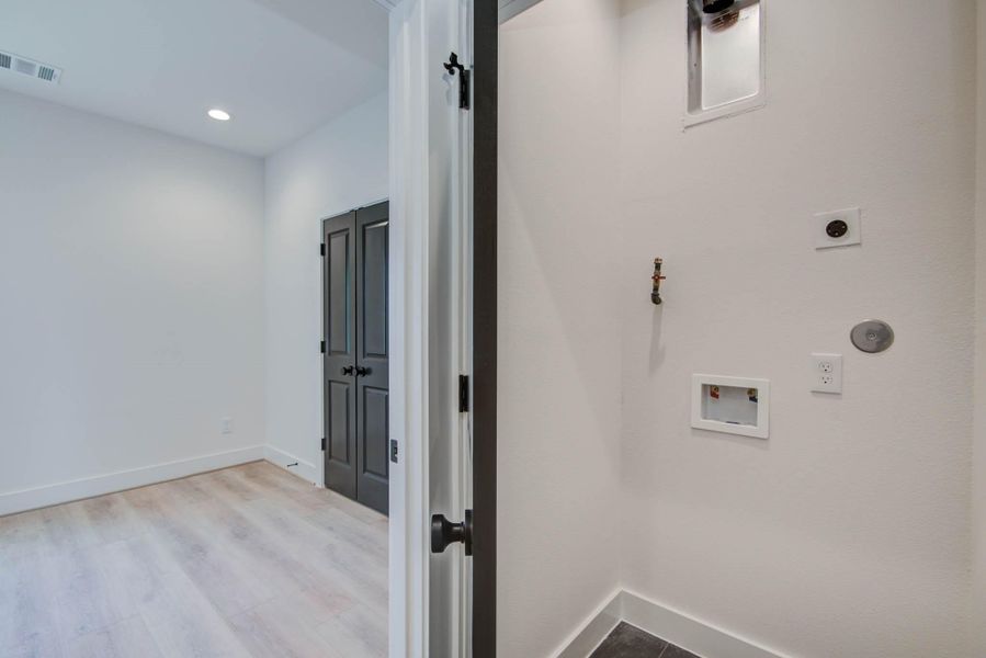 Contemporary townhomes featuring sleek, modern facades, large windows, and spacious balconies, offering stylish urban living.