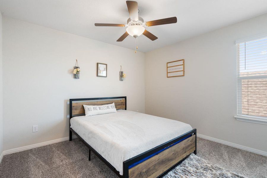 Comfortable secondary bedroom with neutral tones, ceiling fan, and plush carpeting. Comfortable secondary bedroom with neutral tones, ceiling fan, and plush carpeting.