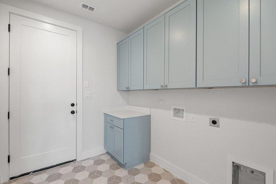 Laundry room featuring light floors, washer hookup, electric dryer hookup, and cabinet space