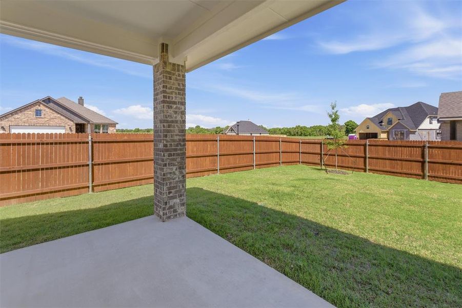 Fenced backyard featuring a patio and a residential view