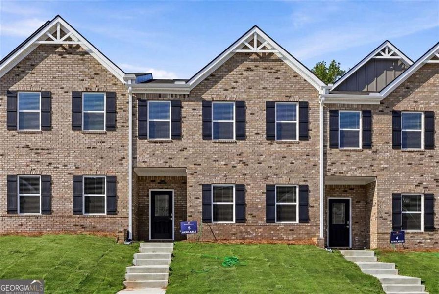 Front exterior of a new home in Parkway James, Snellville, GA, highlighting curb appeal (Image 1). Front exterior of a new home in Parkway James, Snellville, GA, highlighting curb appeal (Image 1).