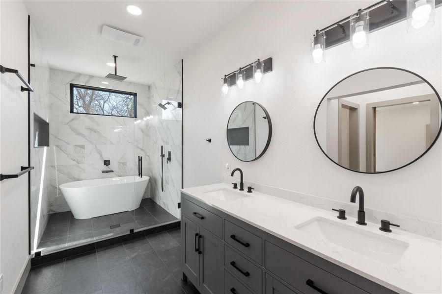 Bathroom with a sink, a marble finish shower, visible vents, and double vanity