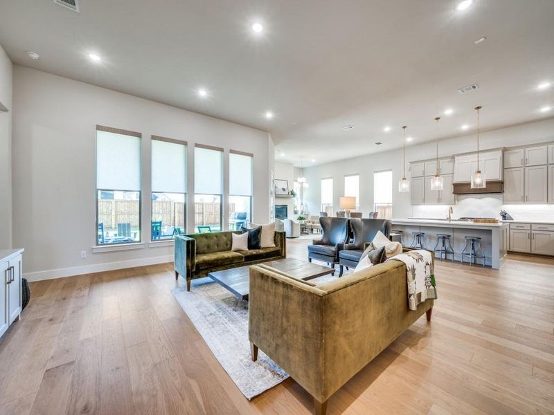 Living area featuring recessed lighting, light wood-style flooring, and baseboards