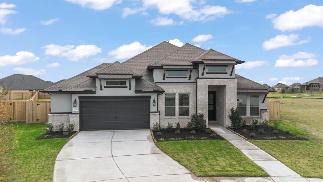Front exterior of a new home in Valencia, Manvel, TX, highlighting curb appeal (Image 1). Front exterior of a new home in Valencia, Manvel, TX, highlighting curb appeal (Image 1).