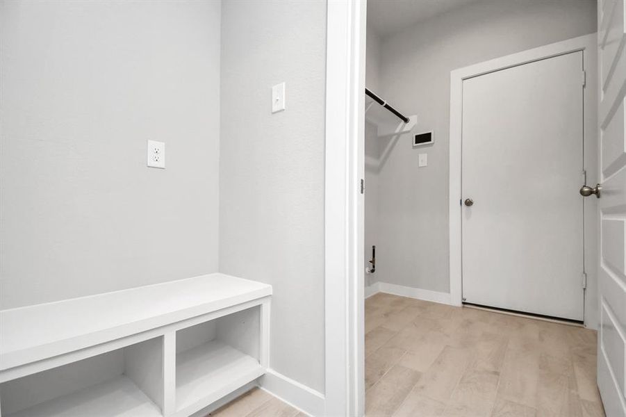 Utility room, conveniently positioned next to a built-in highly functional mudroom. Functionality with a touch of style with this upgrade. Sample photo, as built color and selections will vary.