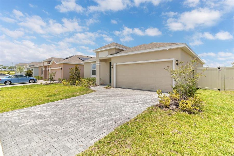 Front exterior of a new home in Tarpon Bay, Haines City, FL, highlighting curb appeal (Image 23). Front exterior of a new home in Tarpon Bay, Haines City, FL, highlighting curb appeal (Image 23).