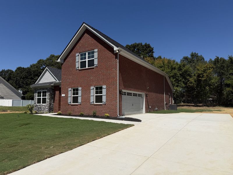 Front exterior of a new home in Sagewood, Tullahoma, TN, highlighting curb appeal (Image 2). Front exterior of a new home in Sagewood, Tullahoma, TN, highlighting curb appeal (Image 2).