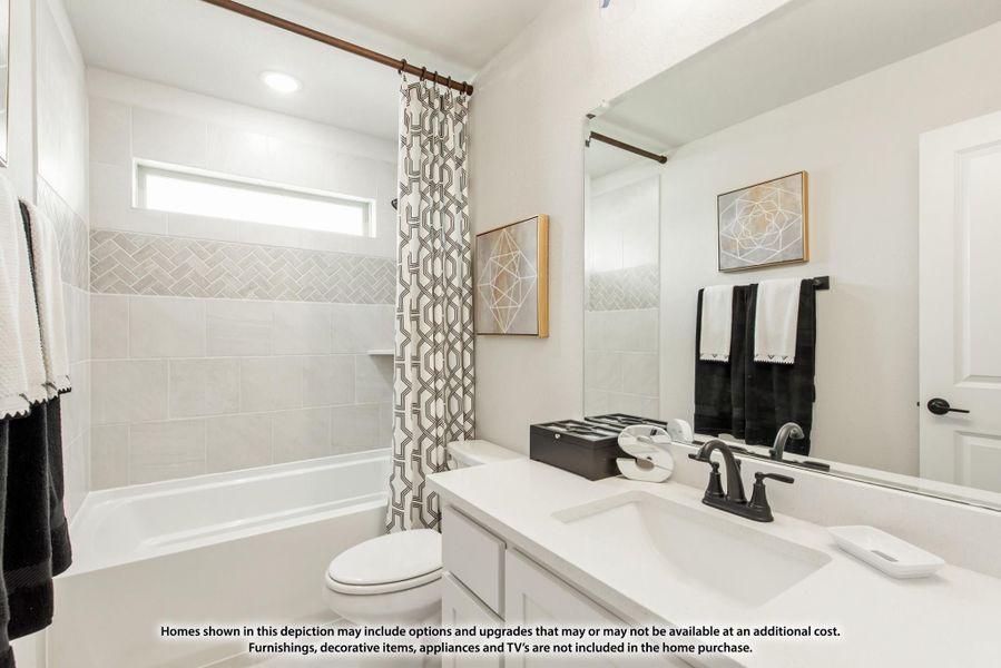 Bathroom with white vanity, tub-shower combo, herringbone tile surround, and large mirror