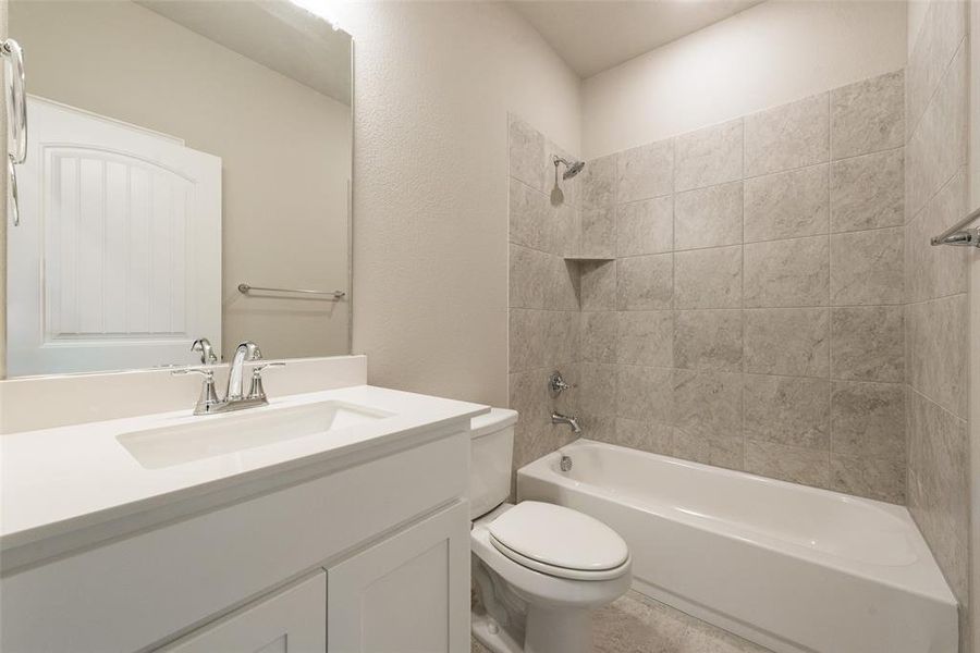 Full bath with vanity, tub / shower combination, and a textured wall