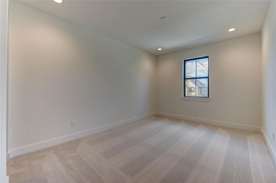 The second out of the three secondary bedrooms on the second floor The second out of the three secondary bedrooms on the second floor