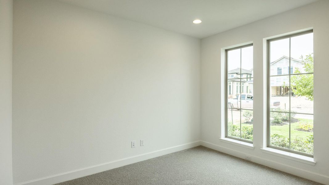 Carpeted empty room featuring baseboards and recessed lighting Carpeted empty room featuring baseboards and recessed lighting
